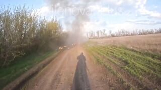 A Ukrainian drone strikes a moving vehicle carrying russian soldiers