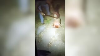 Corpse being dismembered with a machete.