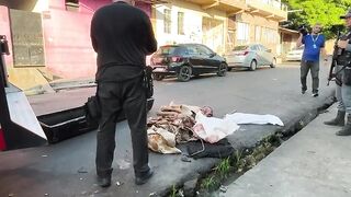 Dismembered corpse in the middle of the street