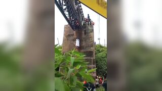 Man in White Robe Found Dead Hanging from Railway Bridge  in Indonesia