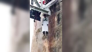 Man in White Robe Found Dead Hanging from Railway Bridge  in Indonesia