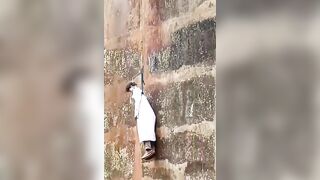 Man in White Robe Found Dead Hanging from Railway Bridge  in Indonesia