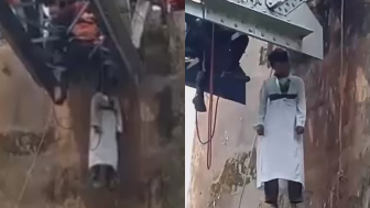 Man in White Robe Found Dead Hanging from Railway Bridge  in Indonesia