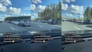 A Russian civilian records other cars waiting for gasoline on the road to Moscow.