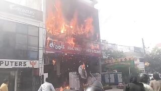 Man Jumps From Burning Building, Lands On Sharp Fencing