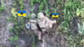 Brave Ukrainian carries his wounded friend.