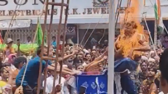 A performer accidentally catching fire during a fire-spitting stunt