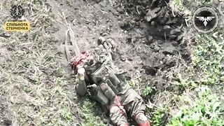 Russian playing dead gets his CAP PEELED by Ukranian drone.