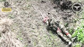 Russian playing dead gets his CAP PEELED by Ukranian drone.