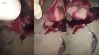 militia member stabs live ISIS captive in the face