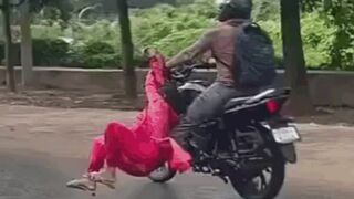 Man Seen Dragging Woman Clinging To His Motorcycle