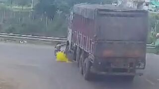 Woman Standing In The Middle Of The Busy Road Gets Run Over By Truck