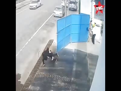 A pedestrian knocked over by an iron gate