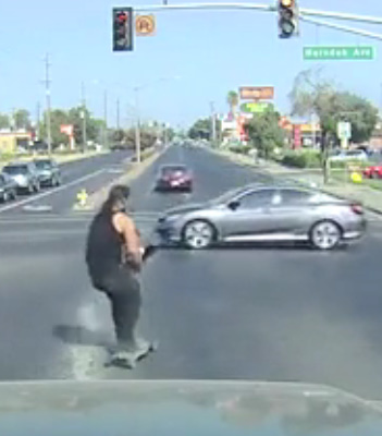 Riding like a maniac, skater crashes at intersection.