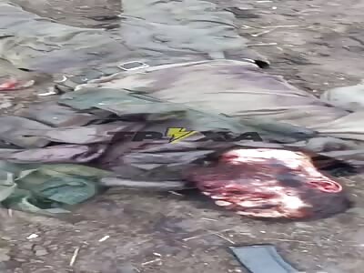 Dead Russian Kadyrov soldier is kicked by a Ukrainian