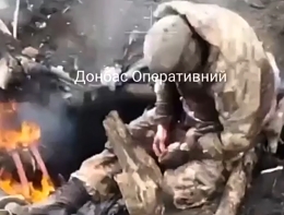 RF soldier climbs out of a burning dugout and falls over