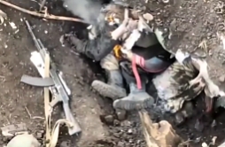 Russian soldier climbs out of a burning hole