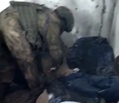 Russian soldiers search body of dead Ukrainian soldier