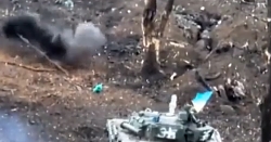 Ukrainian tank fires nearby a Russian held trench