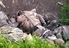 A small trench with multiple dead RU soldiers is shown in Ukraine