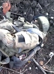 UA soldier shows the dead body of a RU soldier