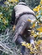 Ukrainian soldier follows a crawling ORC