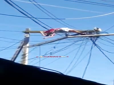 Man being electrocuted on pole.