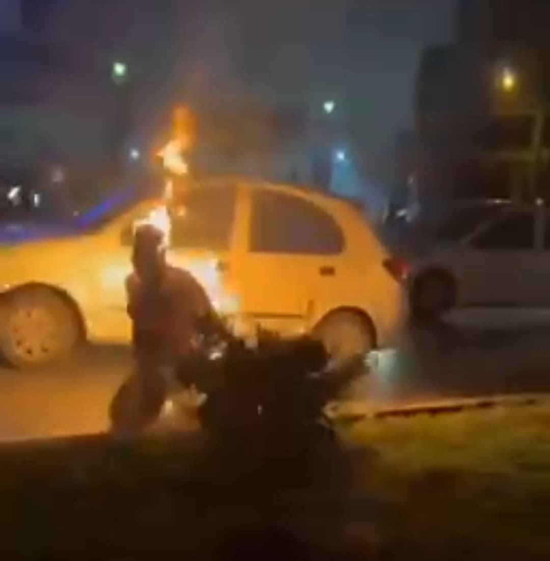 Protesters set fire to a security member of the Iranian