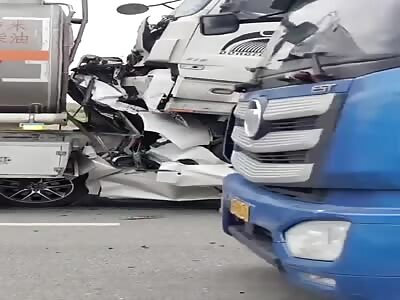 Crushed between two freight trucks