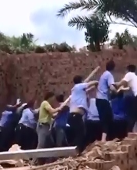 Group of Chinese trying to knock Over a Wall goes Terribly..No they are NOT Polish  (Watch LEft Side) 
