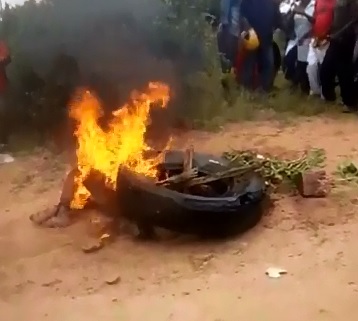 Brutal Murder:  Set on Fire..Twice in a Necklacing Blaze until Smoldering and Suffering to Death 