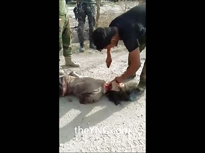 Syrian Soldier Finishes the Beheading of a Young Male or Female? 