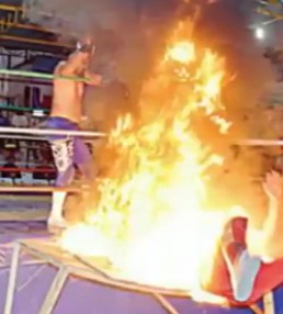Tough Job.. Dude Gets Burned During a WWE Match