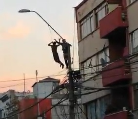 Dude Tries Rescuing the Hanging Man From Pole
