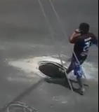 Oblivious Man Talking on His Phone Falls Down Manhole