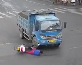 Unlucky Dude Slides Head First into Truck Wheel