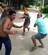 Fellas With Colorful Sticks Beat Chubby Shirtless Guy