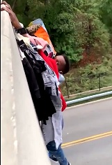 LOL: Thief  Falls From Overpass Clinging to Clothes he Stole.