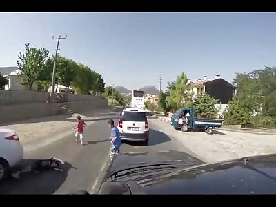 2 KIDS ALMOST HIT BY CAR, ONE GETS HIS LEG FUCKED UP