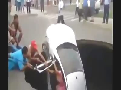 SINKHOLE SWALLOWS CAR AND FAMILY IS RESCUED