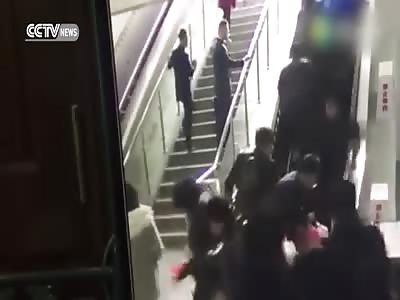 PEOPLE THROWN TO THE GROUND BY A REVERSING ESCALATOR