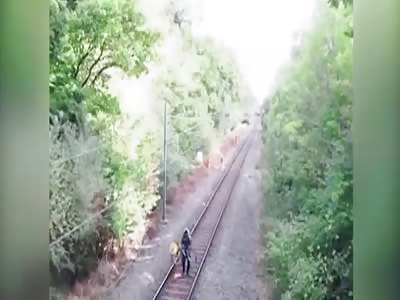 HEROIC RAIL WORKER RISKS LIFE TO SAVE DRUNK CYCLIST  ABOUT TO BE HIT BY TRAIN