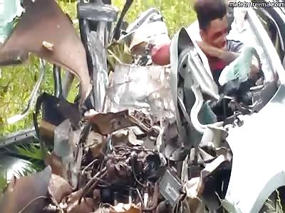 MAN TRAPPED IN CAR WRECKAGE SEEMS HAPPY TO BE ALIVE