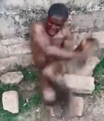 NAKED MAN BEING STONED BY MOB