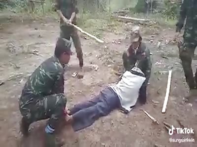 MAN BEING PUNISHED BY SOLDIERS