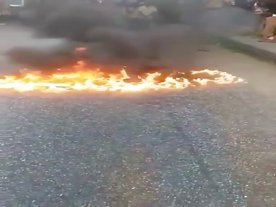 MAN'S BODY BEING BURNED IN THE STREET