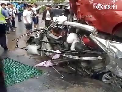 People trapped in car crushed by Truck.