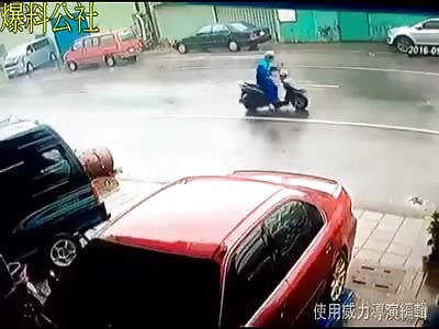 Unlucky Scooter rider is hit by debris during typhoon.