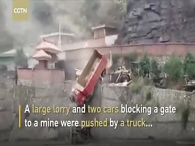 Truck loader pushes vehicles off 10-meter-high platform in dispute