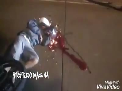 Dead motorcyclist with crushed head